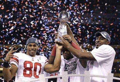 New York Giants - Super Bowl Football New York Giants wide receiver Victor  Cruz (80) holds the Vince Lombardi Trophy during the Super Bowl XLVl  football game against the New England Patriots